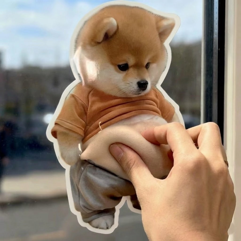 A cute Chubby Shiba Silicone Sticker Protector applied to a wall behind a door handle.