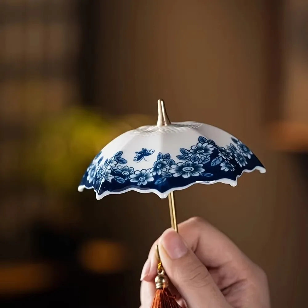 The complete tea strainer set including the umbrella and base