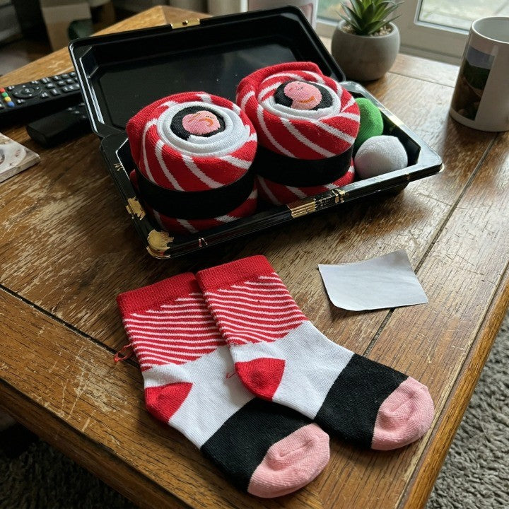 A collection of sushi socks folded to look like a real sushi platter