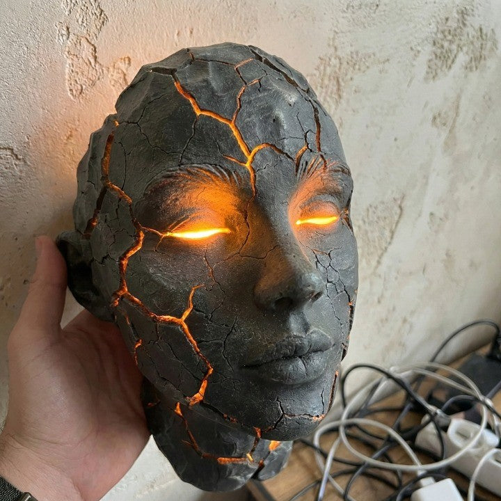The Volcanic Face lamp displayed in a modern living room setting