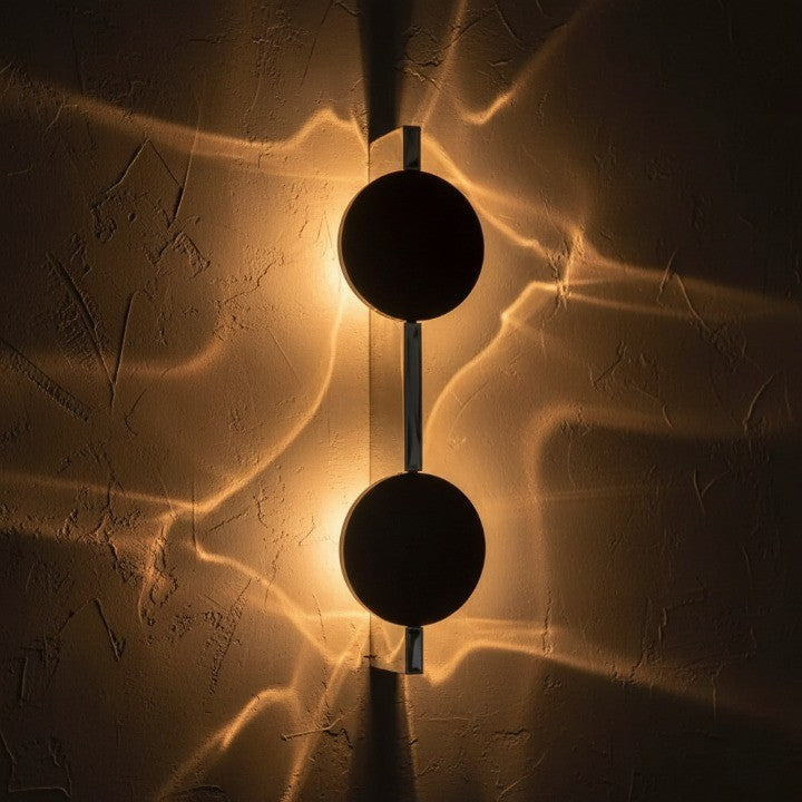 Artistic modern wall light glowing in a dark room
