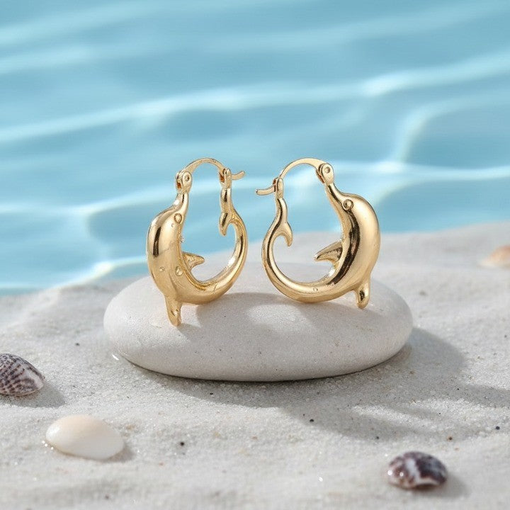 A unique gift idea: the Dolphin Hoop Ocean Inspired Earrings held in hand
