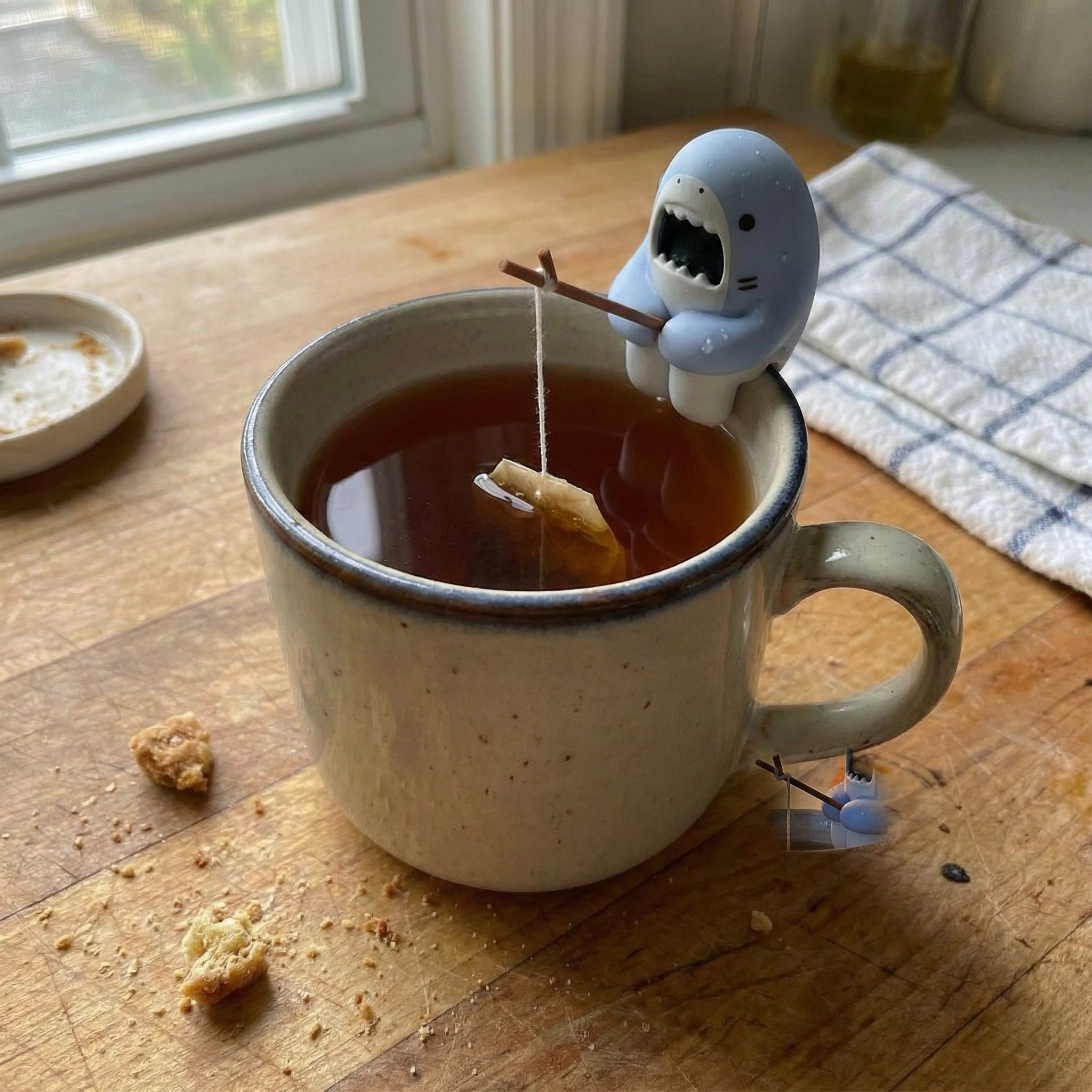 Chill Shark Tea Bag Holder perched playfully on a mug