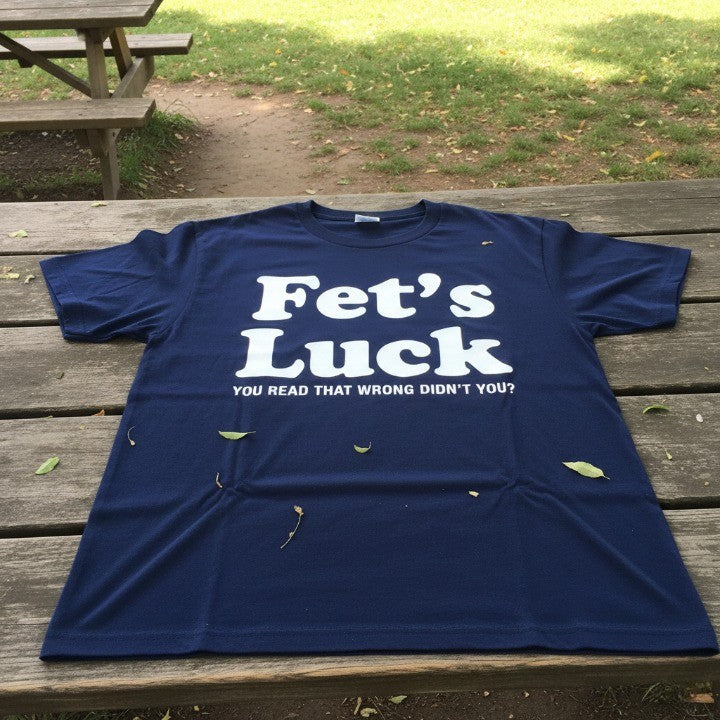 A person wearing the Fets Luck T-shirt in a casual, everyday setting