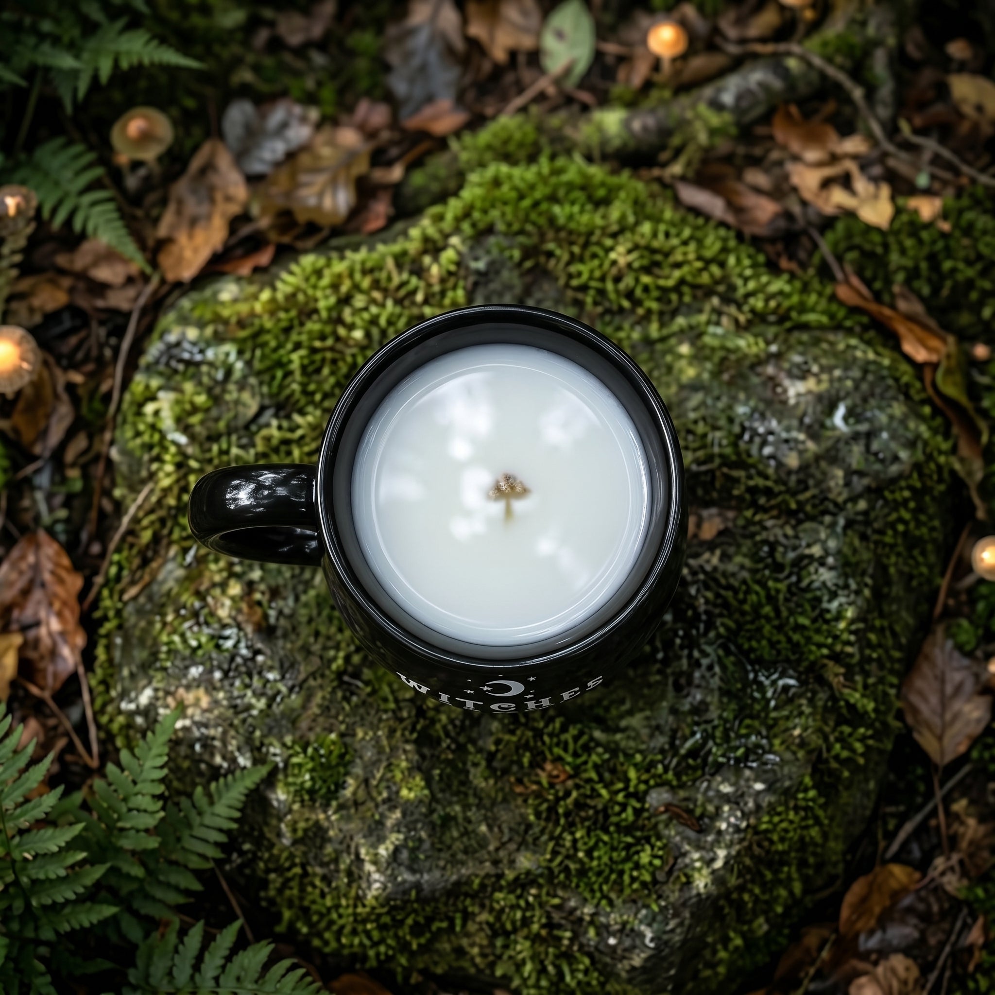A person holding the unique cauldron-shaped coffee mug