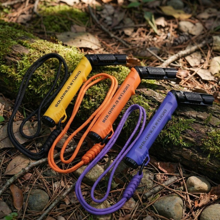 The Military Style Outdoor Fire Starter Lighter being held to show its ergonomic grip and size.