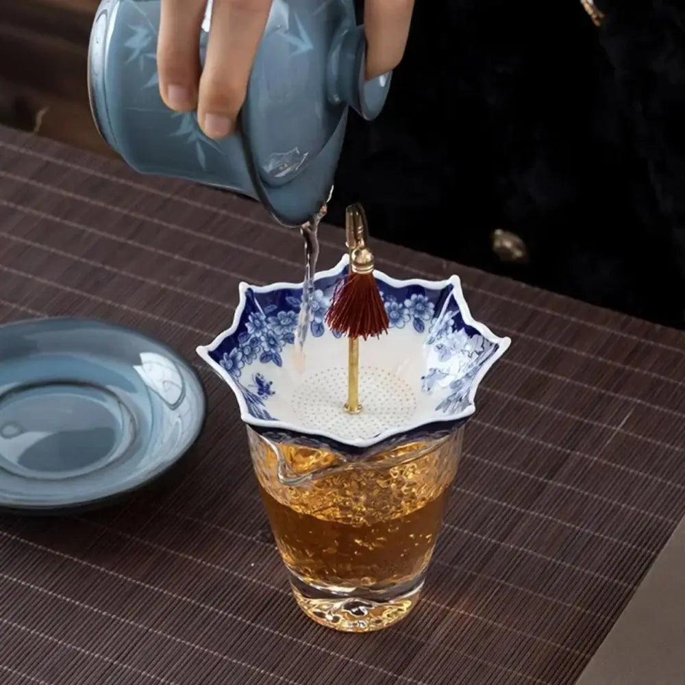 Side view of the Traditional Floral Ceramic Umbrella Tea Strainer on a mug