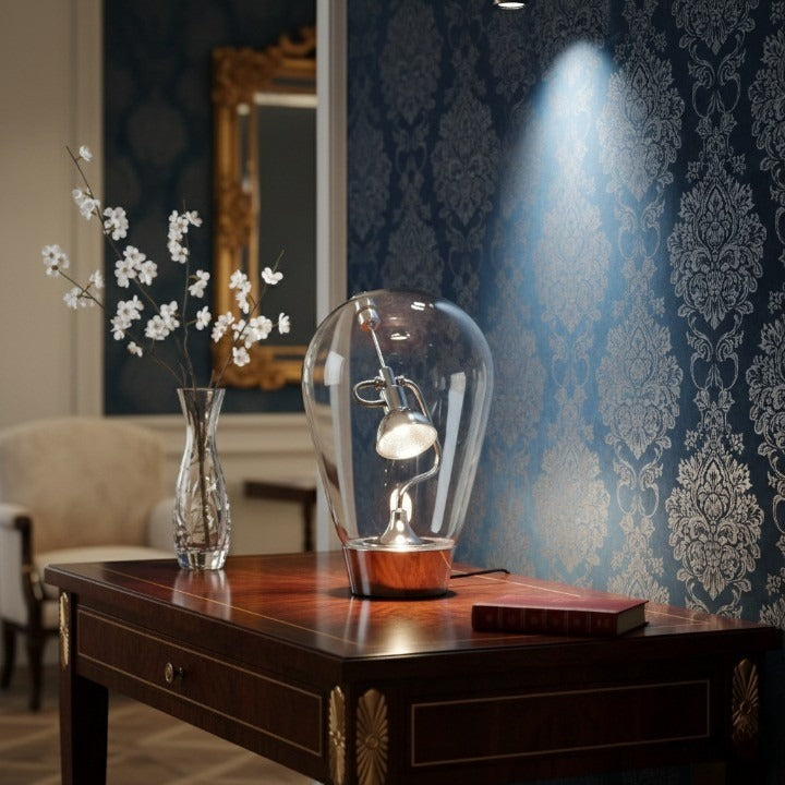 The Glass Halo Sculptural Table Lamp glowing on a modern side table.