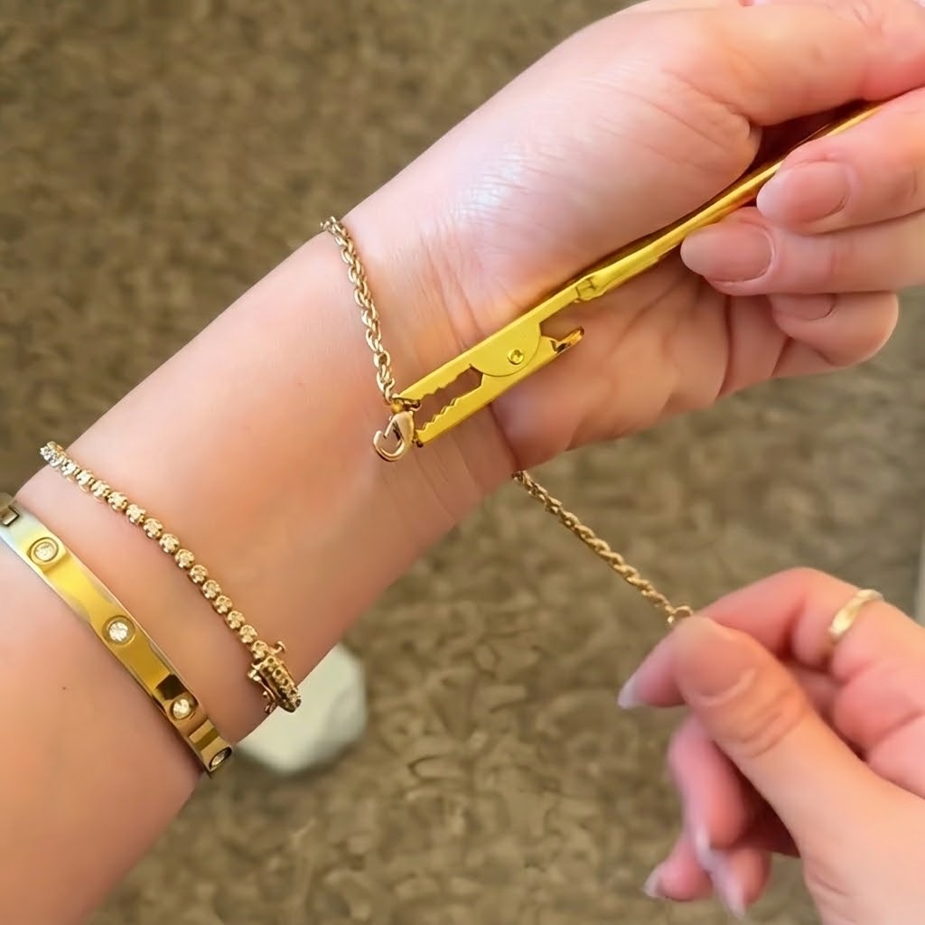 Close-up of the bracelet holder tool securing a delicate chain