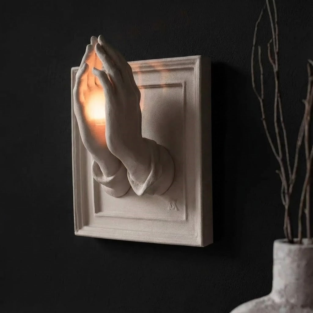 Praying Hands Nordic Wall Candle Holder creating a peaceful ambiance in a living room