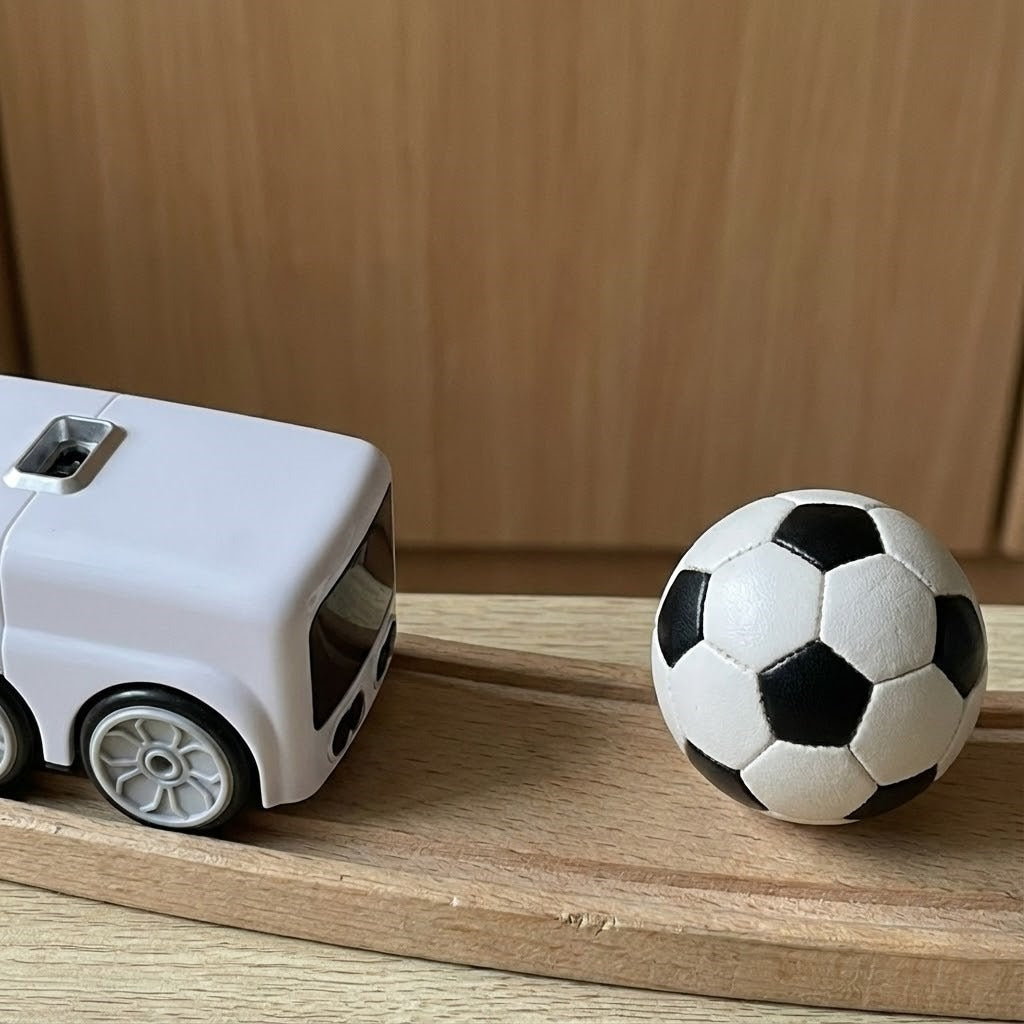 Compact smart RC car on a desk next to a keyboard