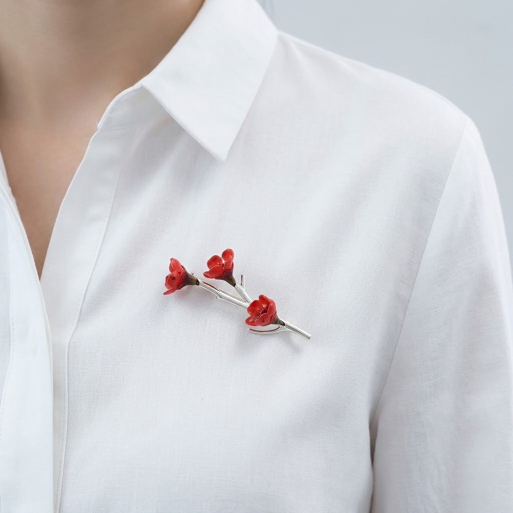 Woman wearing the Wear A Flower Branch Pin Brooch with a small white flower on her coat