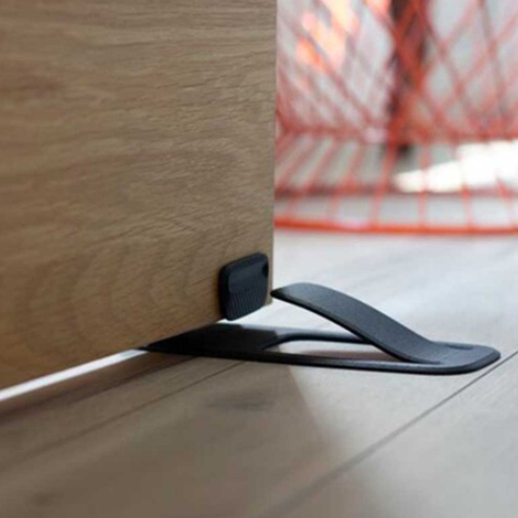 The smart door stopper in use on a modern wooden floor