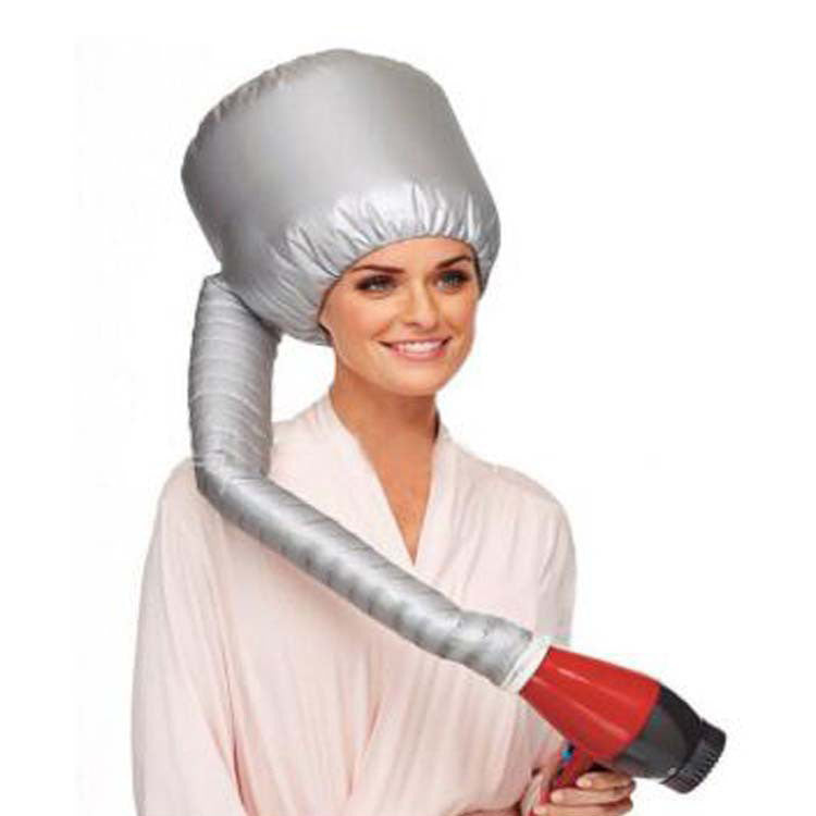 Woman relaxing while using the Fast Hair Drying Cap with a hairdryer