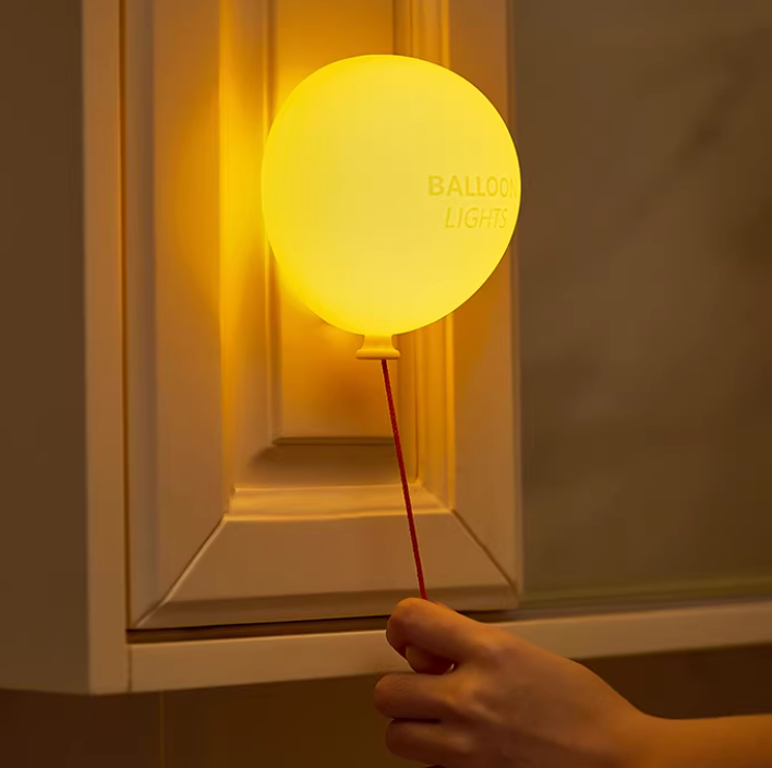 Soft Glow Balloon Night Lamp creating a cozy atmosphere on a nightstand