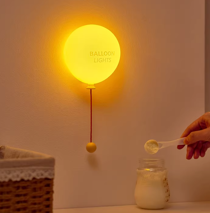 Balloon night lamp being held to show its portable size