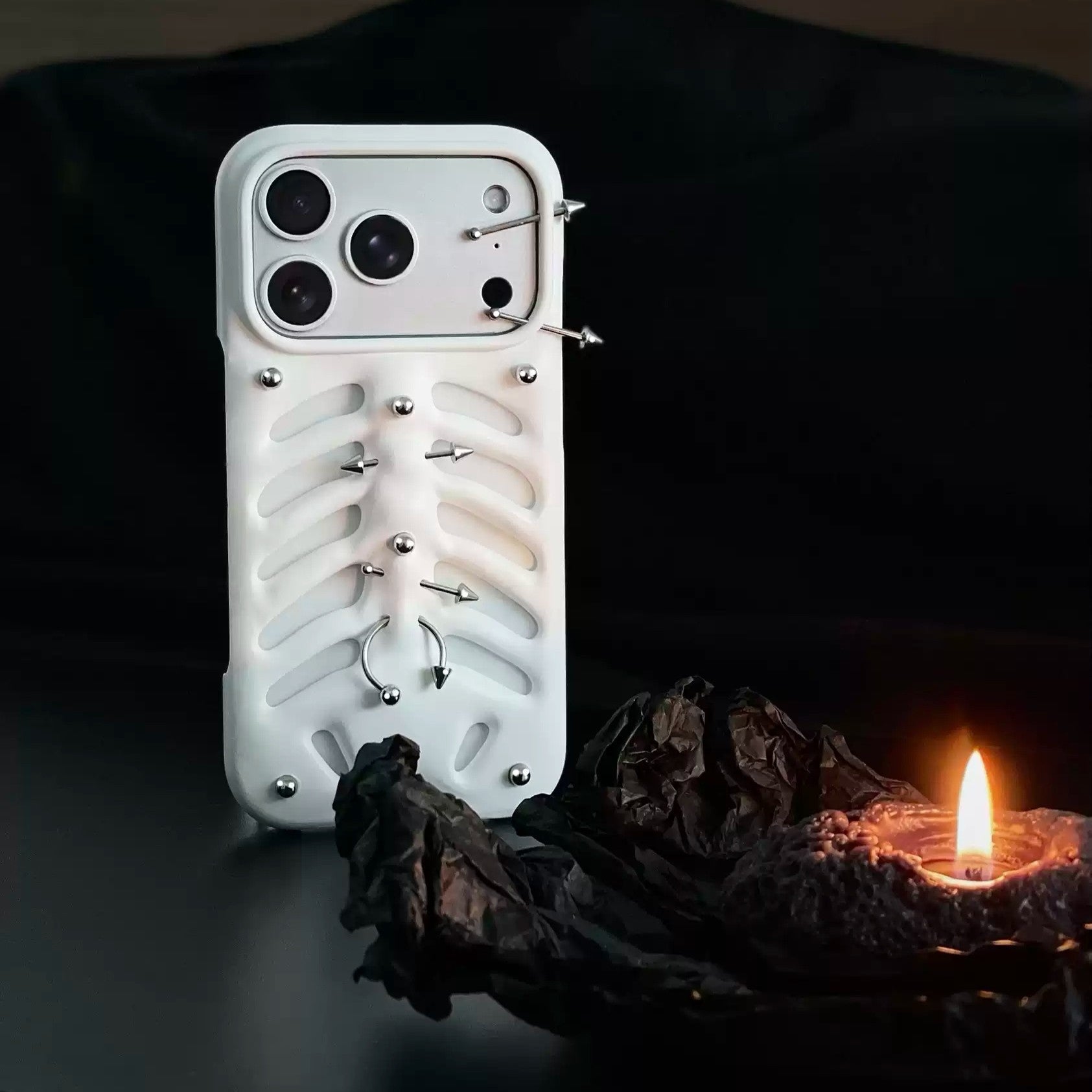 A person holding the white Gothic Ribcage Pierced Phone Case