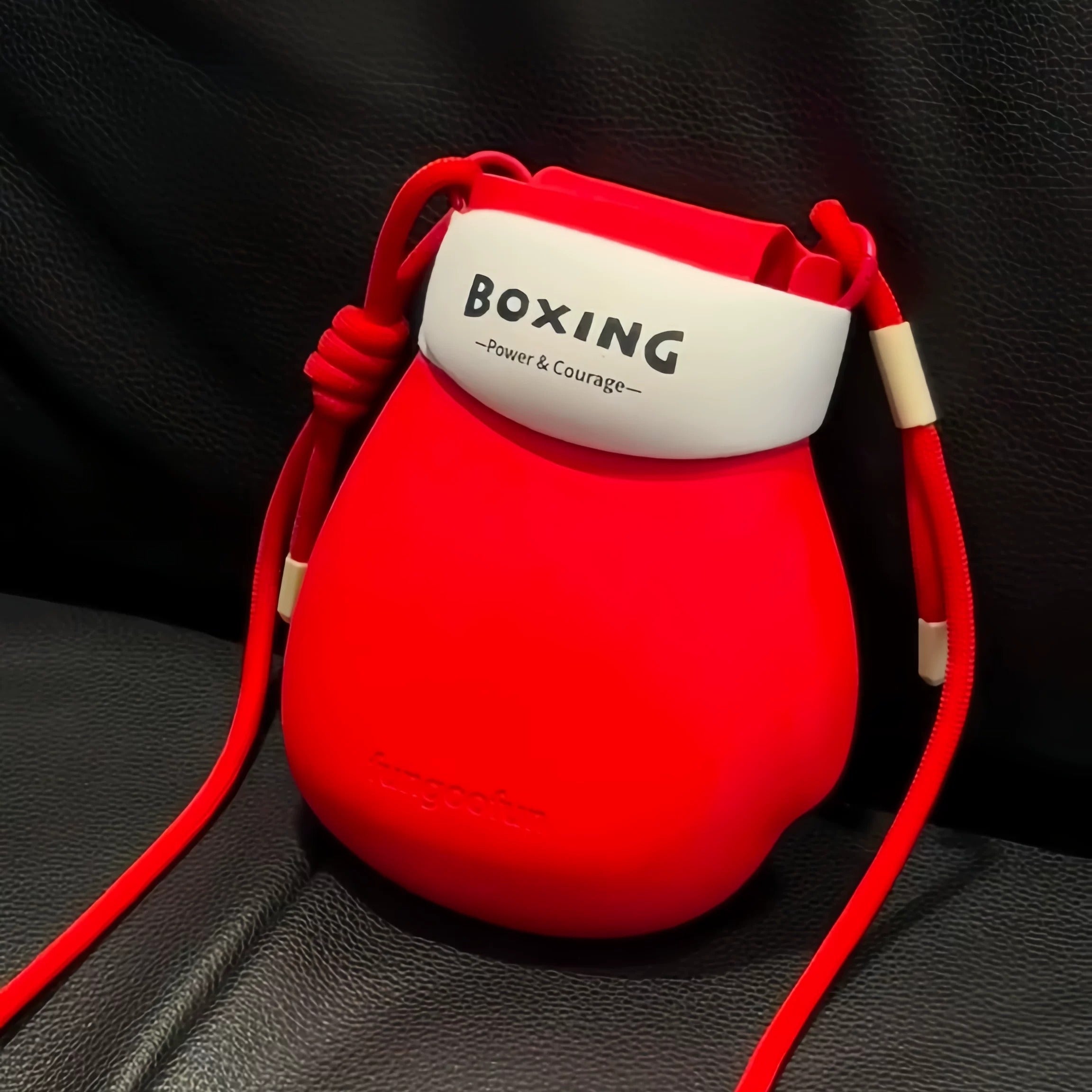 Woman showing off the Ready to Fight Boxing Gloves Mini Bag as a unique statement accessory