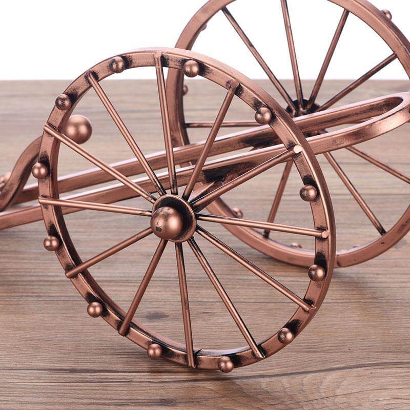 Close-up view of the iron craftsmanship on the cannon wine holder