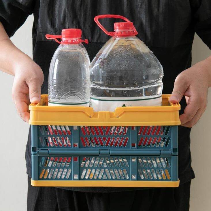 A pink foldable basket being used as a stylish storage solution