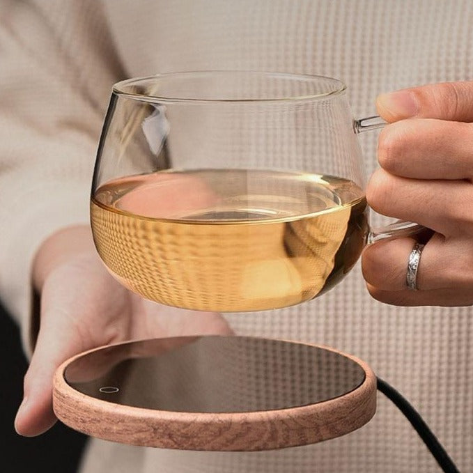 Smart elegant ceramic mug warmer coaster keeping a green mug warm on a desk