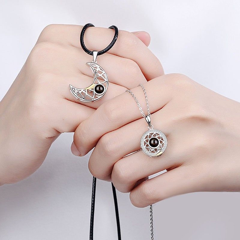 The two magnetic necklace pendants attracting each other to form a complete circle