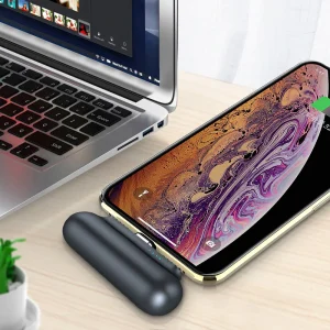Compact magnetic power bank wirelessly charging a smartphone on the go