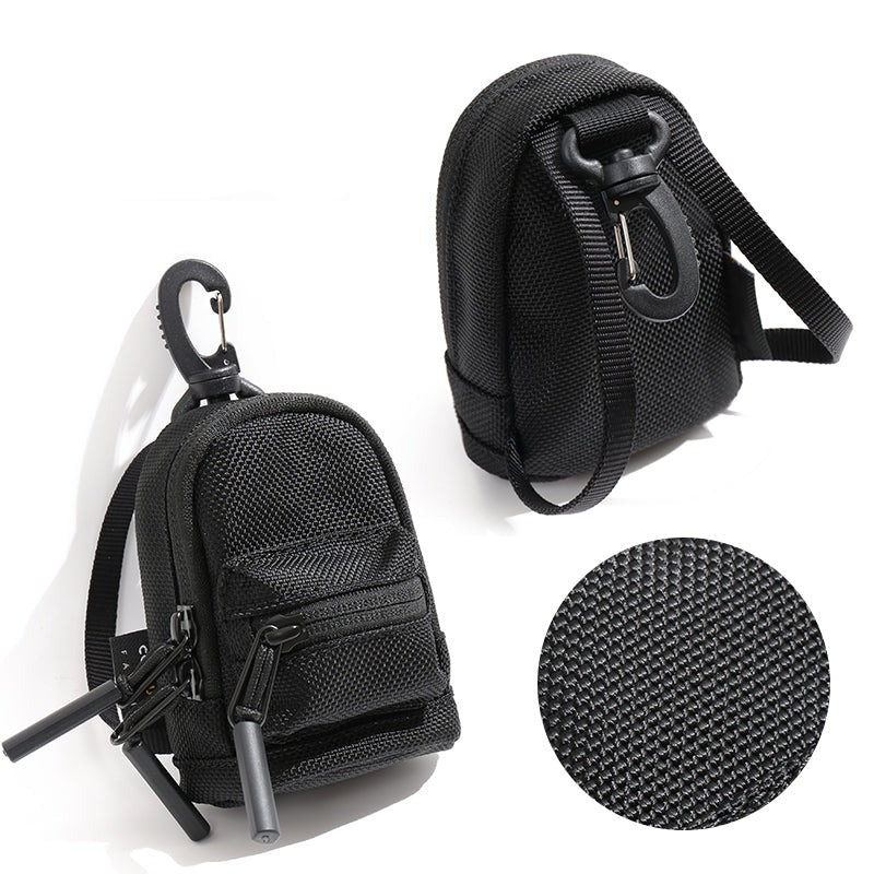 Mini backpack purse attached to a larger backpack for scale