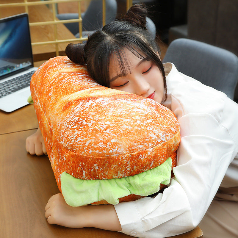 A child happily hugging the plush and soft hamburger pillow
