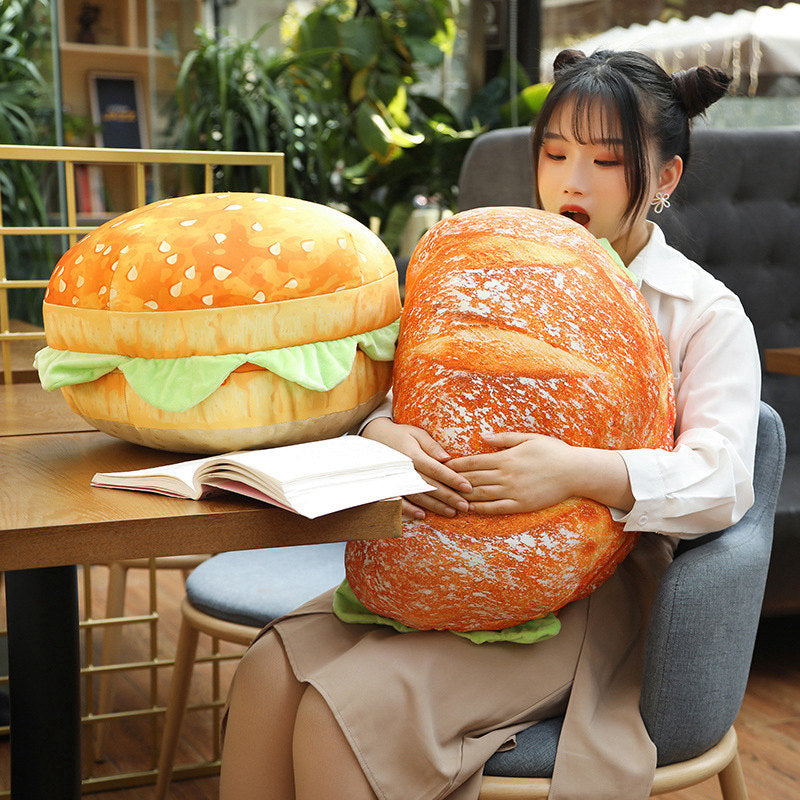 The hamburger pillow being used as a comfy backrest on a sofa