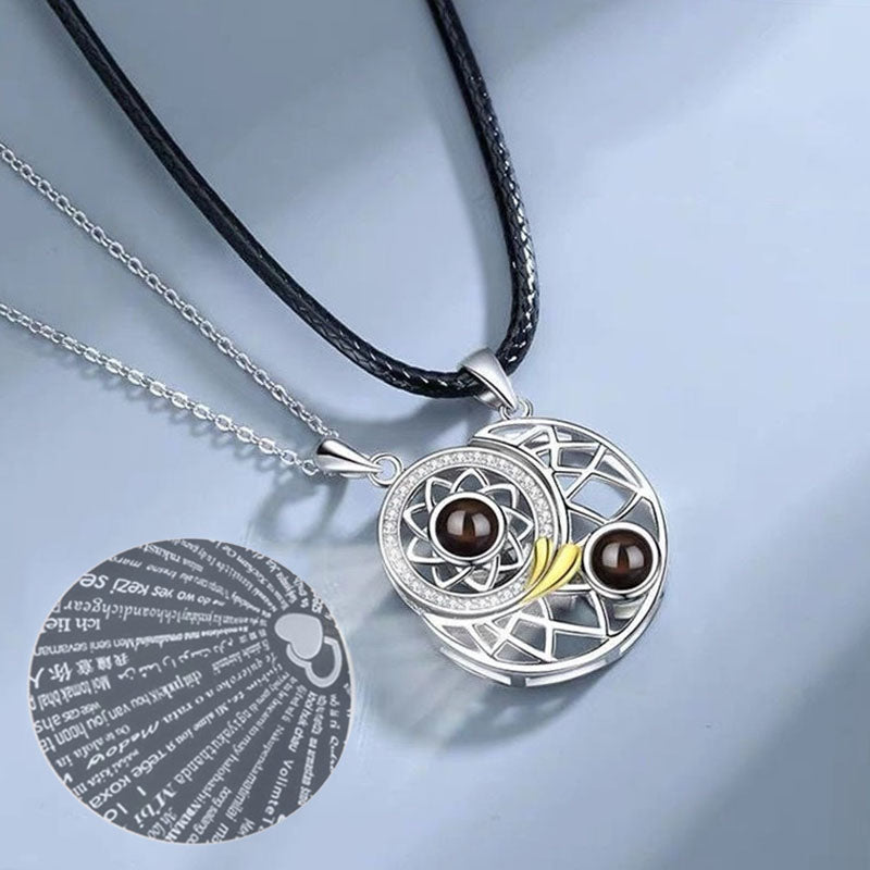Close-up of the sun and moon pendants showing the intricate design and central projection stone