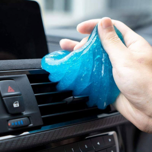 Magic Dust Remover Cleaning Gel being pressed into a car vent