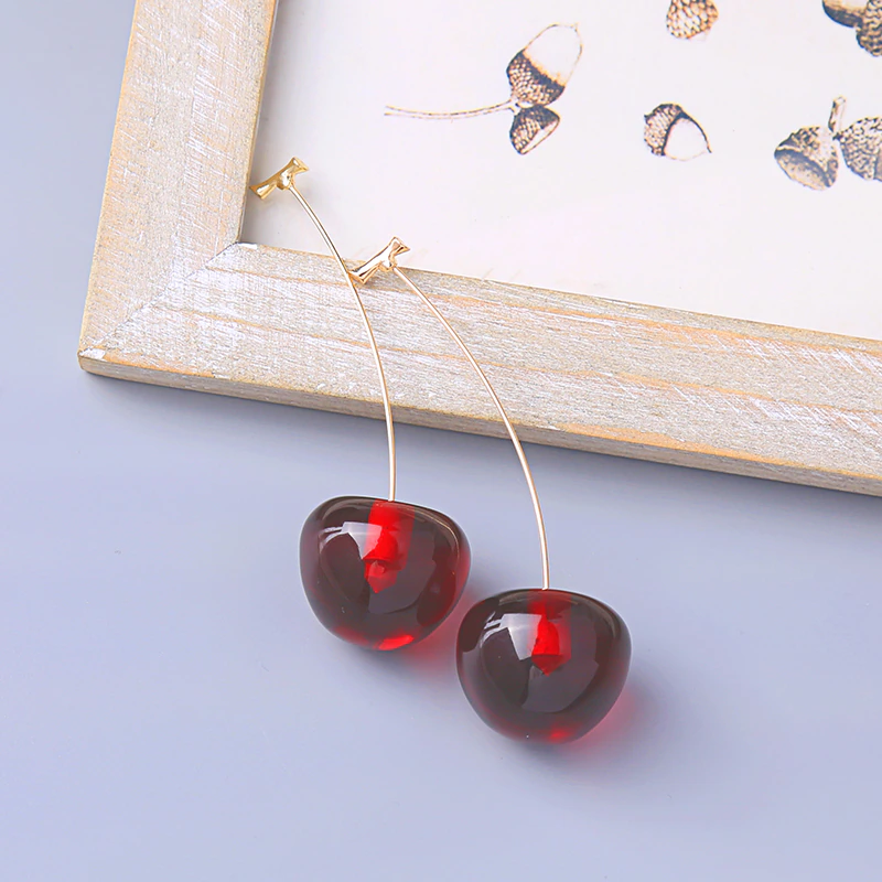 Close-up of the vibrant red cherry earrings