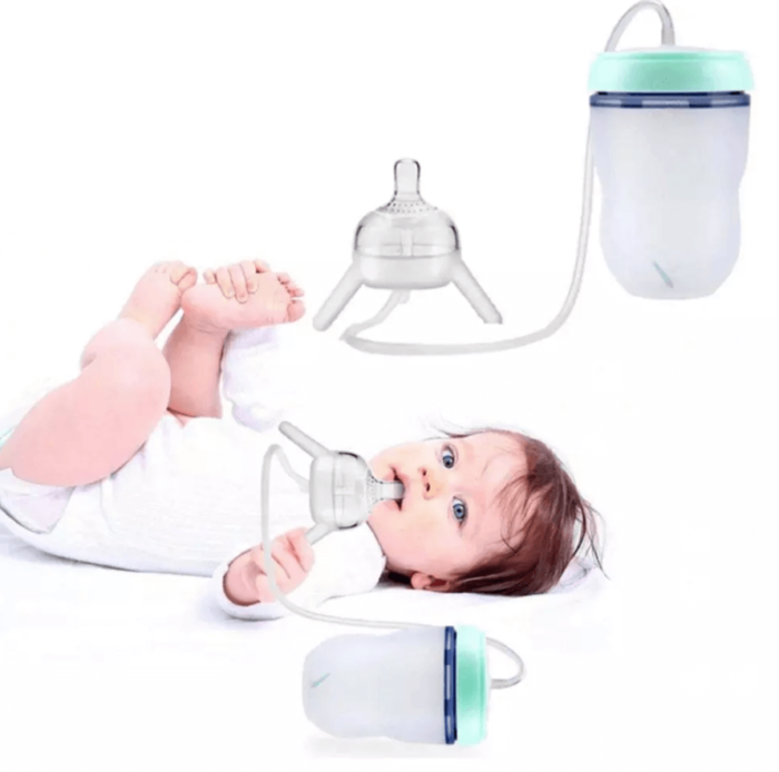Baby feeding themselves with a hands-free flexible bottle while lying down