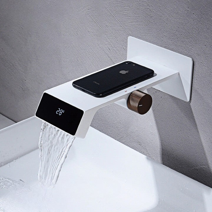 A sleek, futuristic bathroom faucet with a digital temperature display shown in a modern bathroom setting.