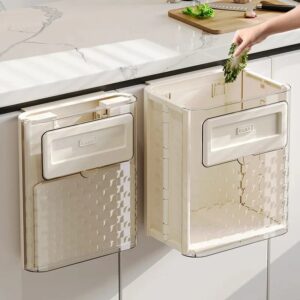Foldable garbage can hanging over a cabinet door, ideal for small kitchens