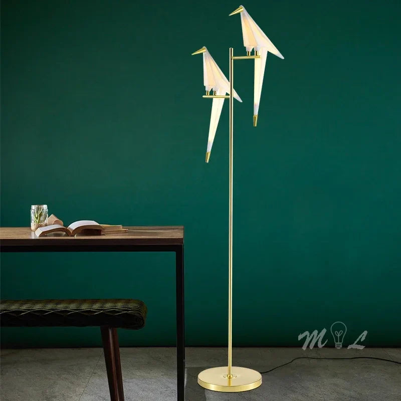 Lifestyle view of the sculptural bird lamp in a home office