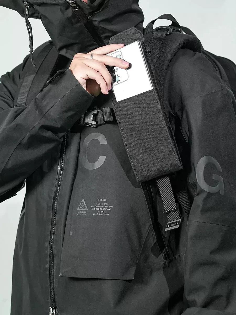 Demonstration of the phone carrier attached to a backpack strap