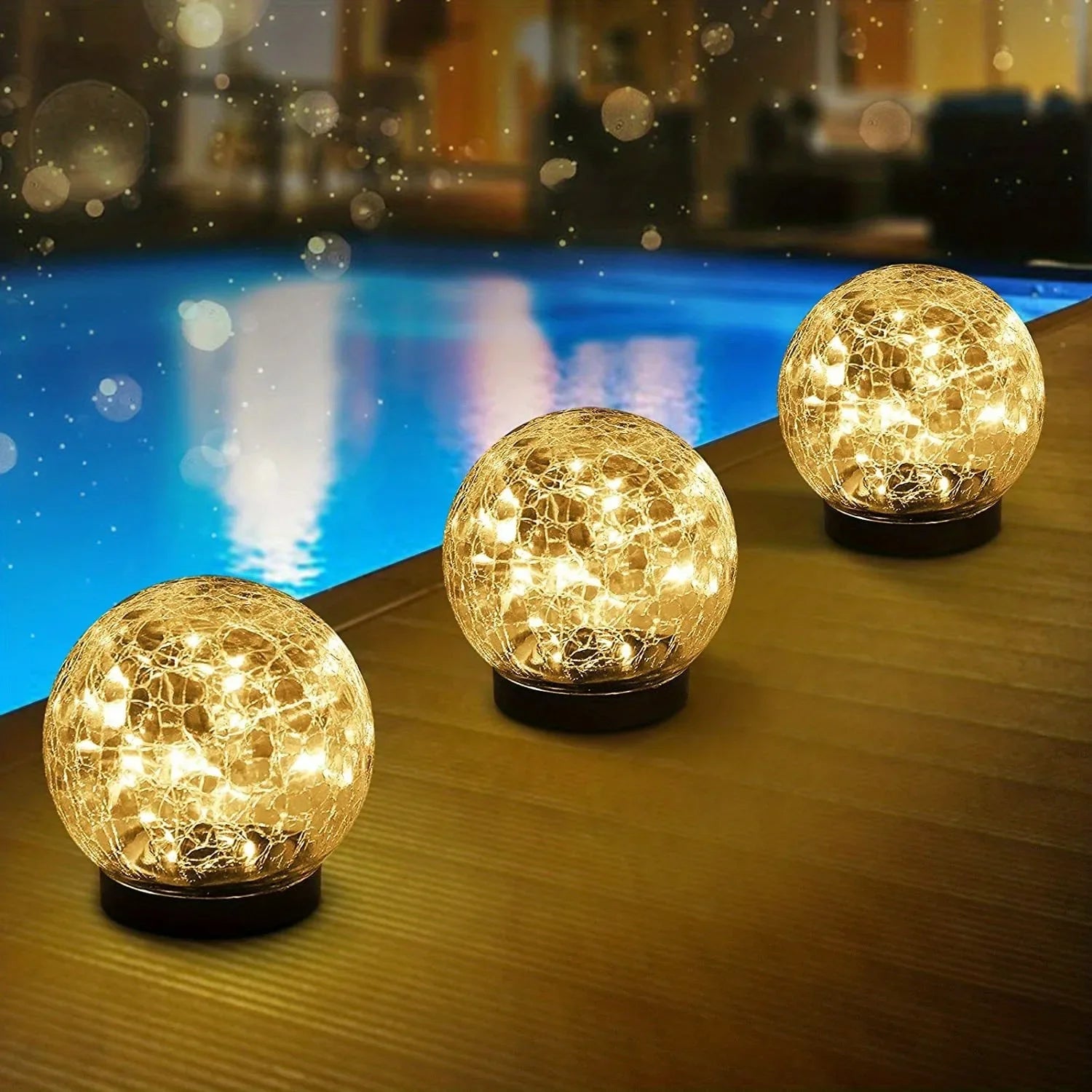 A person admiring the glow of the solar powered glass ball light