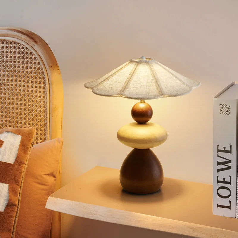 Close-up of the wooden base and soft fabric shade of the Zen lamp