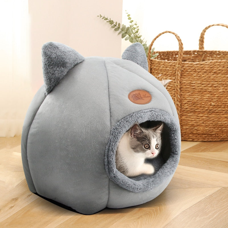 A cat using the Fluffy Cave Cozy Indoor Cat Bed