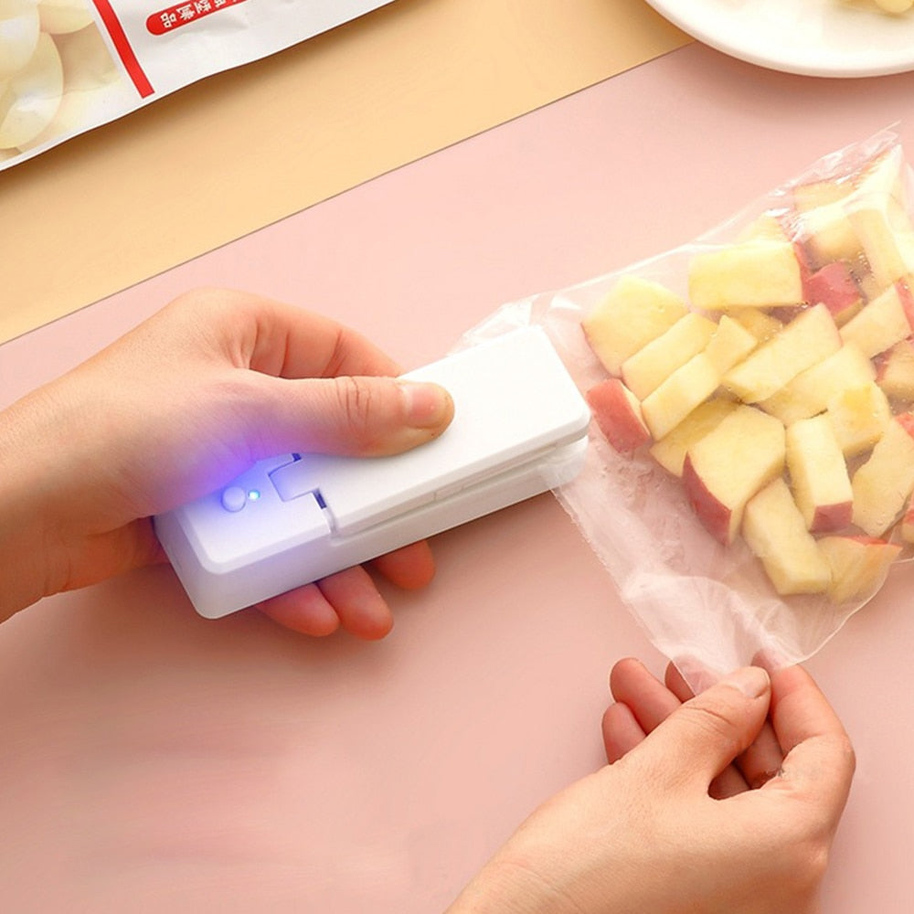 A hand holding the sleek white Chargeable USB Bag Sealer
