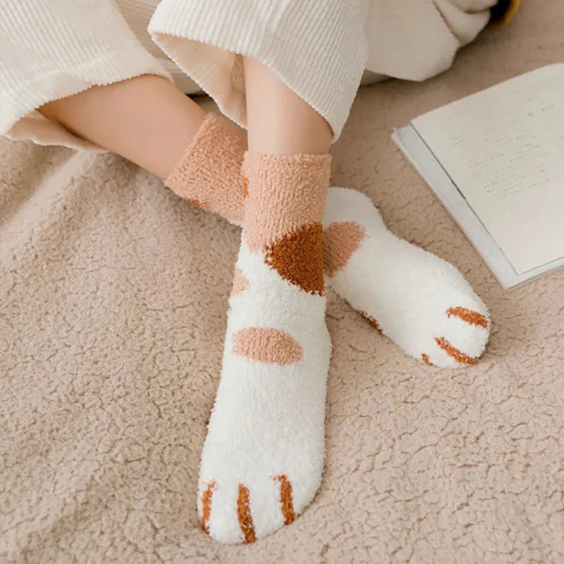 A person wearing the cozy and cute cat paw socks