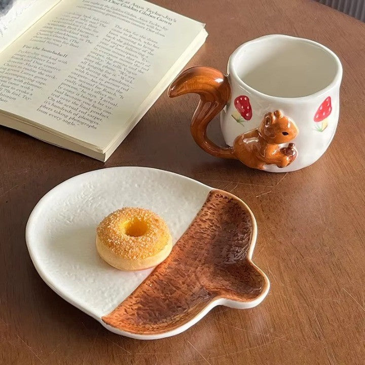 A person holding the Forest Squirrel Artisan Tea Cup