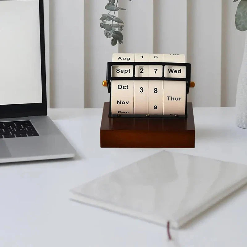 The Mid-Century Rotating Wooden Perpetual Desk Calendar shown in a cozy home office setting