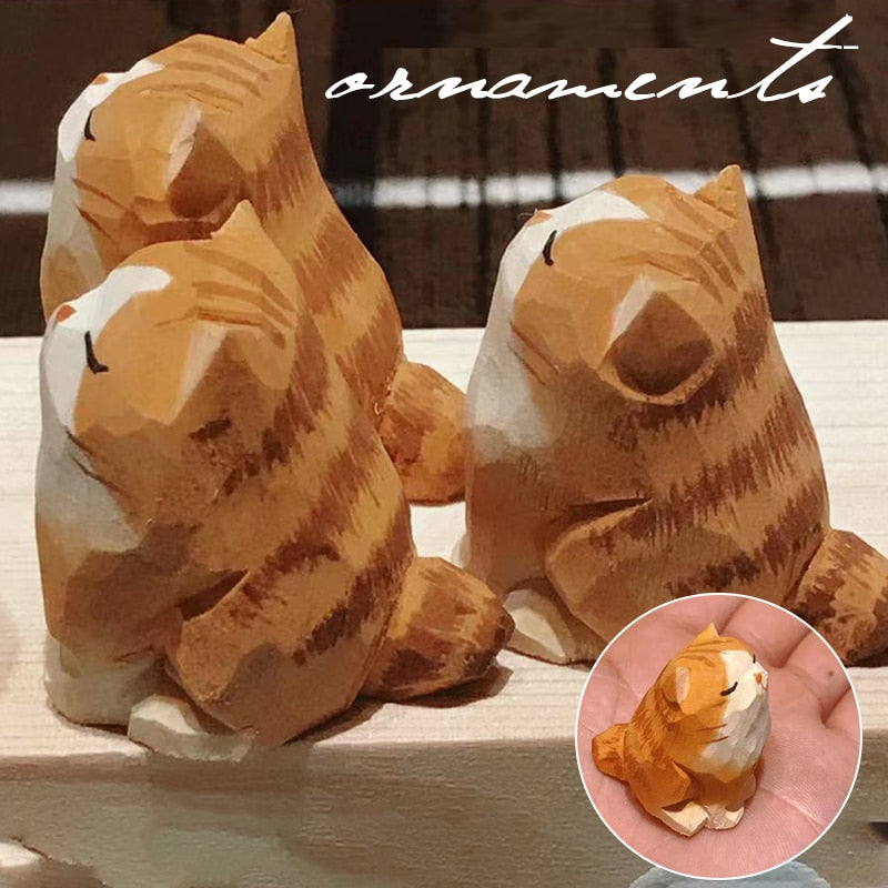 A cute wooden cat figurine sitting on a wooden surface