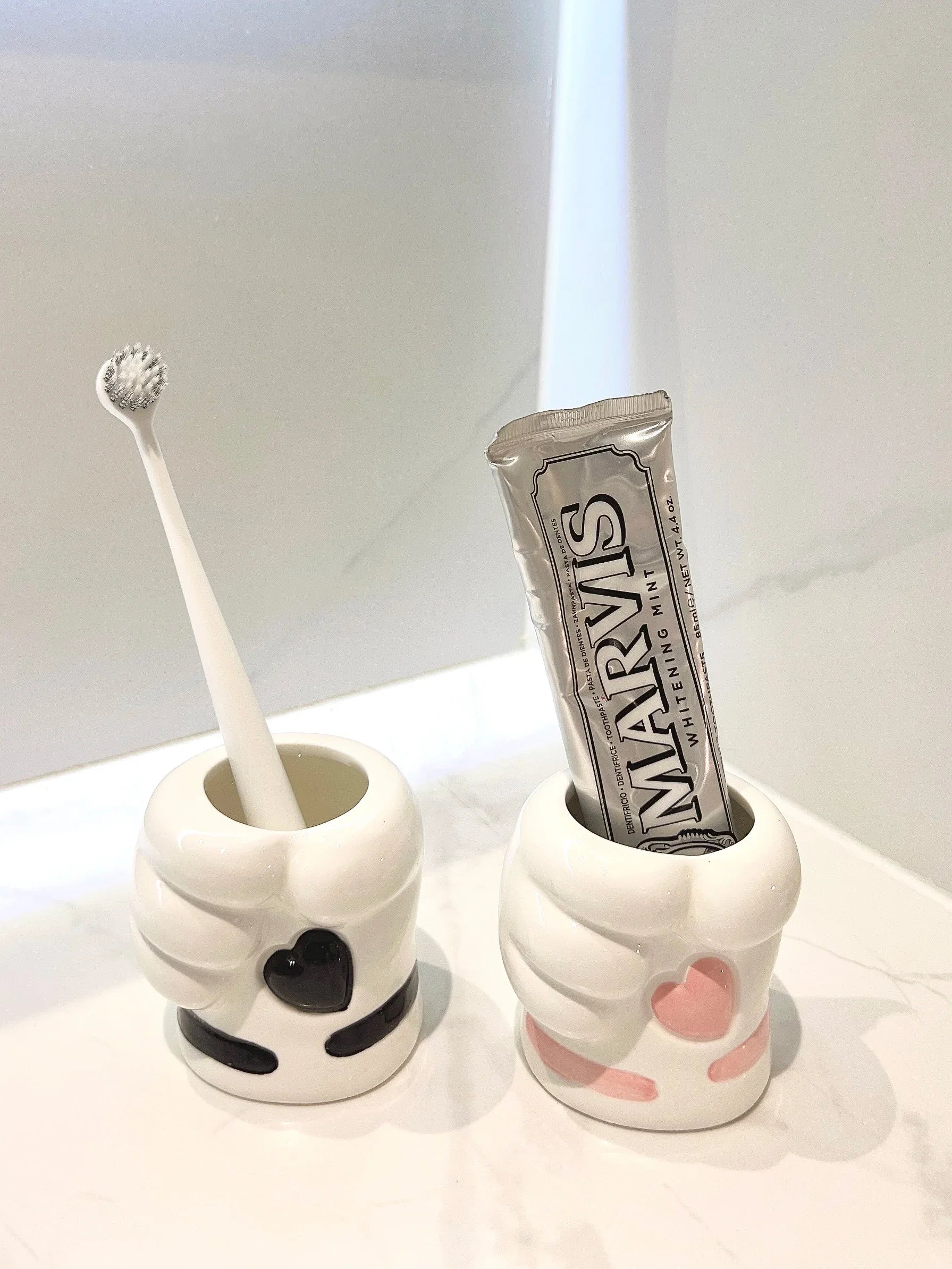 Lifestyle shot of the charming paw soap dispenser by a sink
