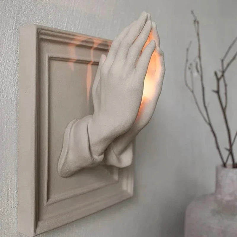 Elegant entryway decor with the praying hands wall sconce