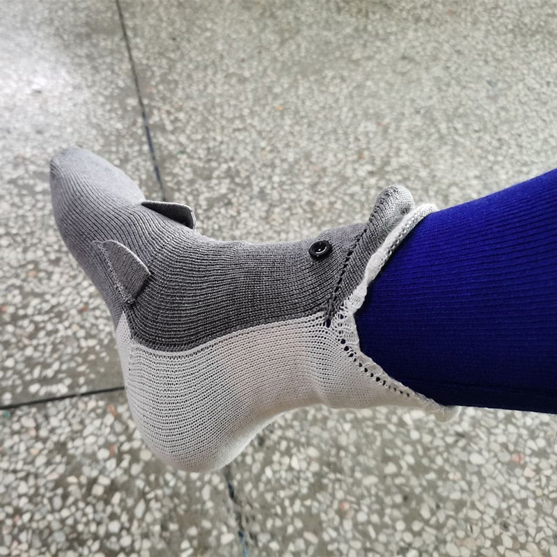 A person relaxing on a couch wearing the cozy Crocodile Bite Knitted Socks.