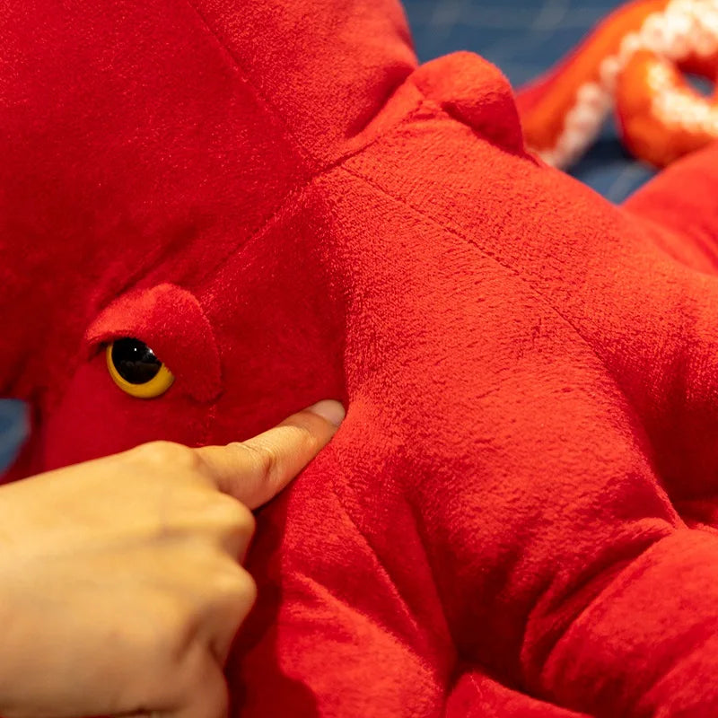 The large red octopus plush toy as a statement piece in a bedroom